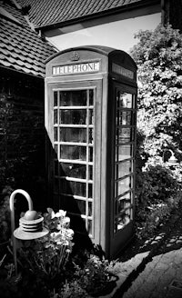 a black and white photo of a telephone booth