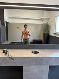 a man standing in front of a mirror