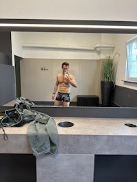 a man is taking a picture of himself in a mirror